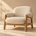 one sculptural cream boucle lounge chair with solid natural oak frame, rounded cushions and contemporary Scandinavian lines