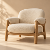 one sculptural cream boucle lounge chair with solid natural oak frame, rounded cushions and contemporary Scandinavian lines