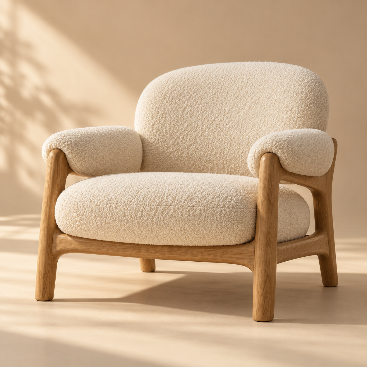 one sculptural cream boucle lounge chair with solid natural oak frame, rounded cushions and contemporary Scandinavian lines