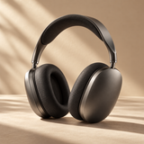 premium over-ear headphones in matte charcoal aluminum, soft black ear cushions and sculptural curved headband