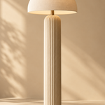 one tall sculptural cream floor lamp with a ribbed cylindrical base and rounded mushroom shade, full height portrait composition