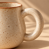 Studio Mug — close-up of the sculptural round handle and its join with the ceramic body
