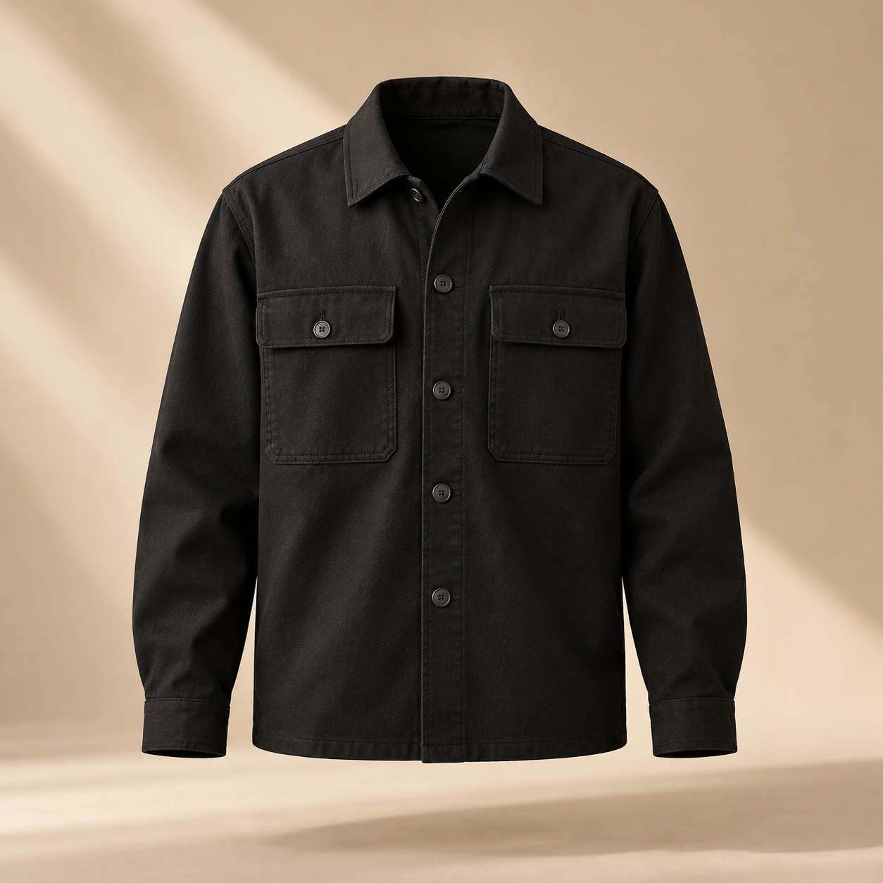 one premium black cotton twill overshirt with two square chest pockets, tonal buttons and relaxed tailored silhouette, invisible mannequin full front view, no person