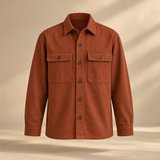 one premium rust cotton twill overshirt with two square chest pockets, tonal buttons and relaxed tailored silhouette, invisible mannequin full front view, no person