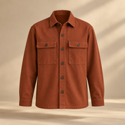 one premium rust cotton twill overshirt with two square chest pockets, tonal buttons and relaxed tailored silhouette, invisible mannequin full front view, no person
